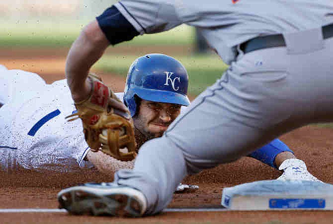 Kansas City Royals' Eric Hosmer is tagged out by Houston Astros third baseman Matt Dominguez during the first inning of a baseball game at Kauffman Stadium in Kansas City, Mo., Saturday, June 8, 2013. Hosmer was out trying to stretch an RBI double. 