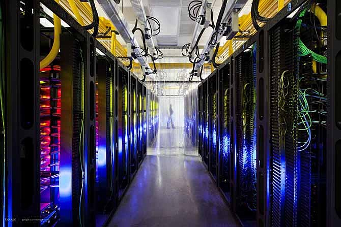 This undated photo made available by Google shows the campus-network room at a data center in Council Bluffs, Iowa. Routers and switches allow Google's data centers to talk to each other. The fiber cables run along the yellow cable trays near the ceiling. 