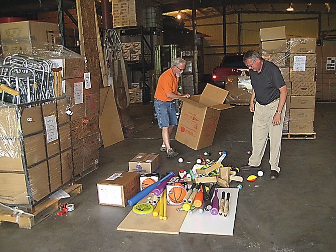 A Department of Defense official looks over some of the items area Rotarians have collected in a Jefferson City warehouse. Tons of items are bound for Panama via the Missouri National Guard and U.S. Air Force.