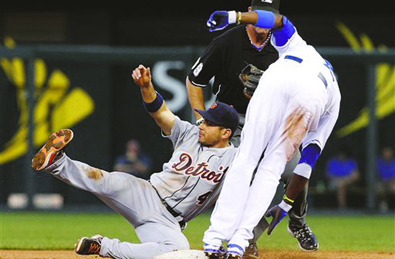 The Royals' Alcides Escobar is tagged out by Tigers second baseman Omar Infante during the fifth inning of Tuesday's game at Kauffman Stadium in Kansas City.