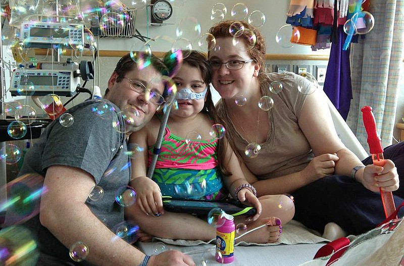 Sarah Murnaghan, center, celebrates the 100th day of her stay May 30 in Children's Hospital of Philadelphia with her father, Fran, left, and mother, Janet. The 10-year-old suburban Philadelphia girl received a lung transplant Wednesday, her family said.