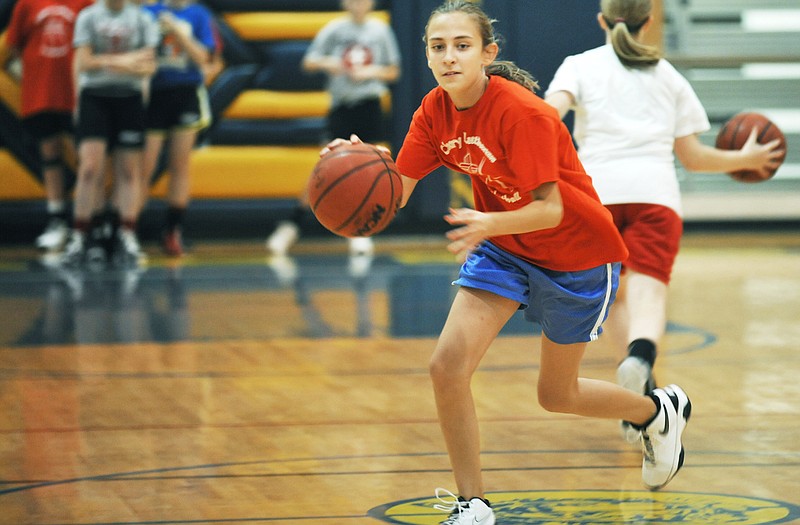 Madi Wilson competes in a ballhandling drill during the Calvary Lutheran girls basketball camp Thursday at the Trinity Lutheran gym.