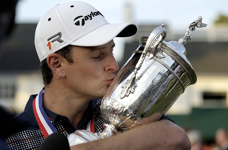 Justin Rose kisses the trophy after winning the U.S. Open on Sunday at Merion Golf Club  in Ardmore, Pa.