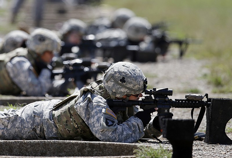 In this Sept. 18, 2012 file photo, female soldiers from 1st Brigade Combat Team, 101st Airborne Division train on a firing range while testing new body armor in Fort Campbell, Ky., in preparation for their deployment to Afghanistan. Women may be able to begin training as Army Rangers by mid-2015, and as Navy SEALs a year later under broad plans Defense Secretary Chuck Hagel is approving that would slowly bring women into thousands of combat jobs, including those in the country's elite special operations forces, according to details of the plans submitted to Hagel that were obtained by The Associated Press.