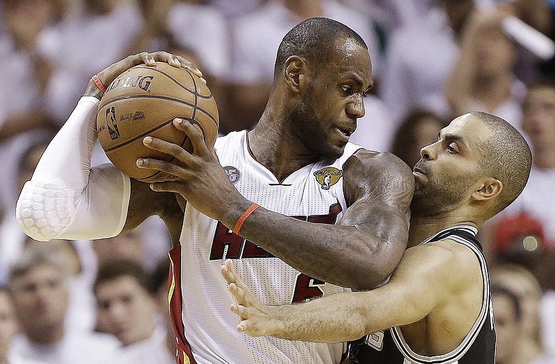 Spurs guard Tony Parker and Heat forward LeBron James collide during the second half of Game 6 of the NBA Finals on Tuesday in Miami.