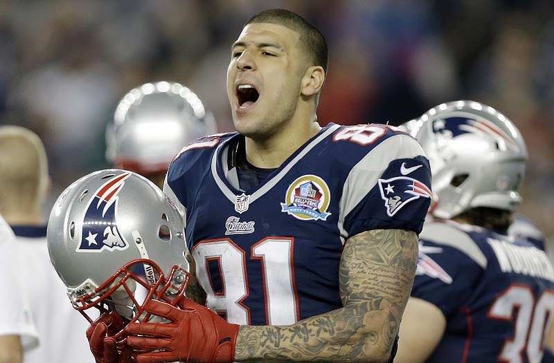 Patriots tight end Aaron Hernandez reacts during the second quarter of a game last season against the Texans in Foxborough, Mass. State and local police spent hours at the home of Hernandez on Tuesday as another group of officers searched an industrial park about a mile away where a body was discovered the day before. 