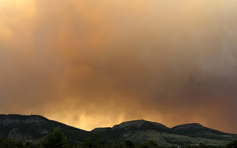 Wildfire smoke blankets a ridge Sunday near Alpine, Colo. A large wildfire near a popular summer retreat in southern Colorado continues to be driven by winds and fueled by dead trees in a drought-stricken area, authorities said Sunday.