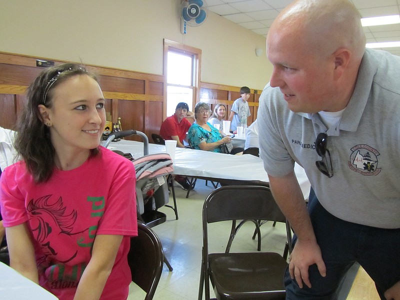 Emily Beul, left, chats with Colin Wright of Cole County EMS during Sunday's benefit for Beul, who was seriously injured in a March 8 car wreck in Jefferson City. Wright was one of the first people at the scene to attend to her after the wreck.