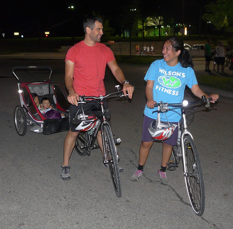Jessica and Aaron Lackman of Holts Summit pull into the Hy-Vee parking lot after riding 15 miles in the Department of Parks and Recreation's annual Tour de Jeff Moonlight Bike Ride. The Lackmans brought with them their two children, Isabel, 4, and Ethan, 1. "It was a great night for riding," Jessica said.