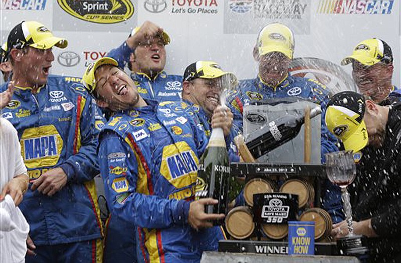 Martin Truex Jr. (second from left) sprays his team after winning Sunday's Toyota/Save Mart 300 in Sonoma, Calif.