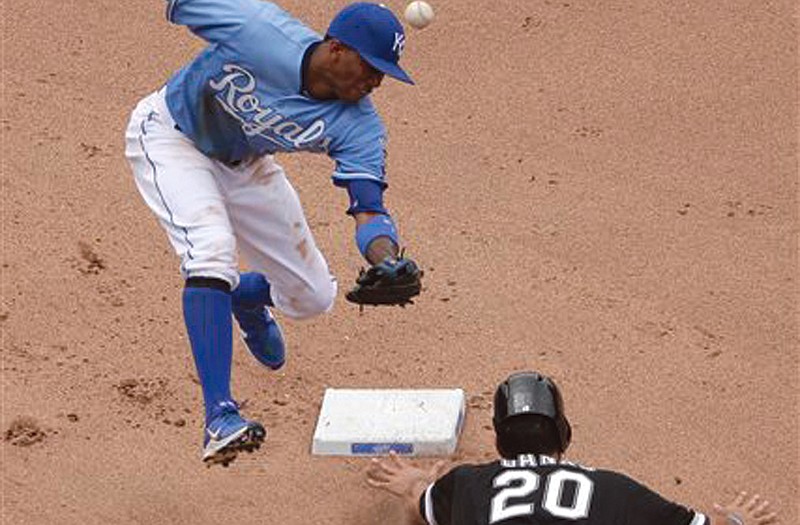 The White Sox's Jordan Danks slides safely into second as Royals shortstop Alcides Escobar tries to come up with the ball during the seventh inning of Sunday's game in Kansas City.