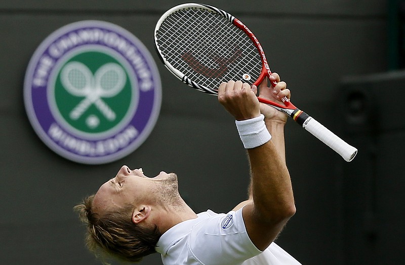 Steve Darcis celebrates after defeating Rafael Nadal in their first-round singles match Monday at Wimbledon.