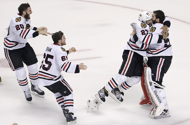 Members of the Chicago Blackhawks celebrate Monday night after winning the Stanley Cup in Boston.