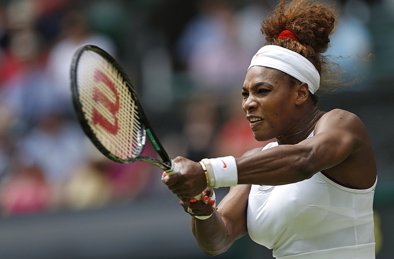 Serena Williams returns the ball to Mandy Minella during their first-round singles match Tuesday at Wimbledon.