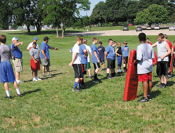Area seventh graders work on blocking at the California Middle School Seventh Grade Football Camp Thursday morning at the CMS practice field. 