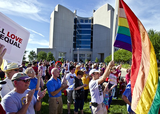 Randy Hite, of Kansas City, waves a flag Wednesday in downtown Kansasy City during a demonstration in reaction to the U.S. Supreme Court's ruling on same-sex marriage.