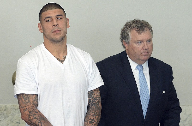 Former Patriots tight end Aaron Hernandez stands with his attorney Michael Fee during arraignment Wednesday in Attleboro, Mass.