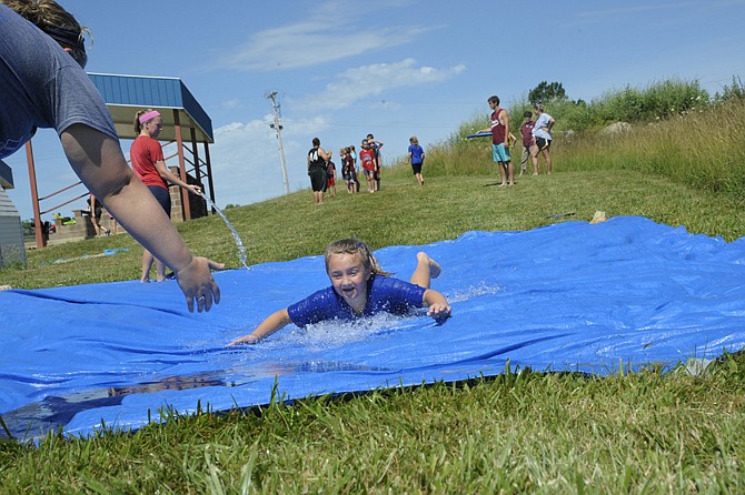 Campers at the Russellville Sports Crusaders camp took to the water as college-athlete coaches instructed them on softball and baseball sliding techniques. Student Hallee Stewart chose to go head first.