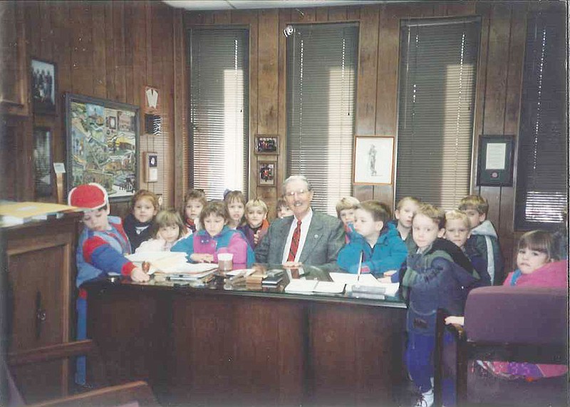 John C. Harris shares his office at The Callaway Bank with a preschool class in January 1995. Harris, who led the bank for more than 60 years and helped start several key community service organizations, died Thursday at the age of 96. Current bank president and CEO Kim Barnes described Harris as someone who "liked people and wanted people to feel valued."