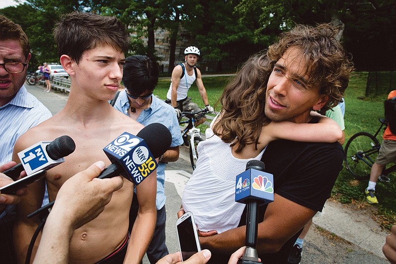 Sebastien Berthelet, from Montreal, speaks to reporters at the 79th Street Boat Basin after helping bring to shore the pilot who made an emergency landing of his helicopter in the Hudson River.