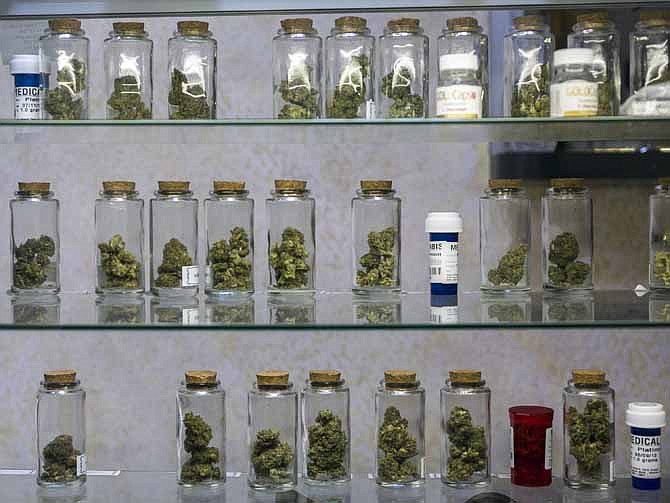 This May 14, 2013 file photo shows medical marijuana vials displayed at the Venice Beach Care Center medical marijuana dispensary in Venice, Calif. 