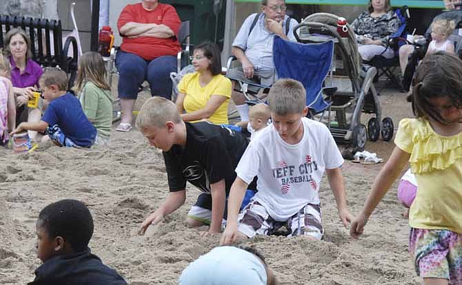 The beach party was in full swing along Madison Street in downtown Jefferson City Thursday night as Thursday Night Live events finished out with a block full of sand. Cade Beckley and Parker Gourley had a blast digging in the sand.