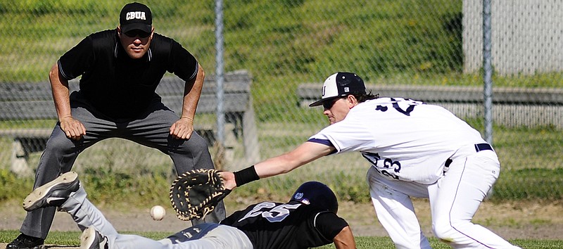 In this 2012 file photo, Lincoln first baseman Isaac Cater reaches for a pick-off throw as Truman State's Steven Rose slides safely back to the base during a Mid-America Intercollegiate Athletics Association contest at Lincoln Field. Truman State officially left the MIAA on Monday.