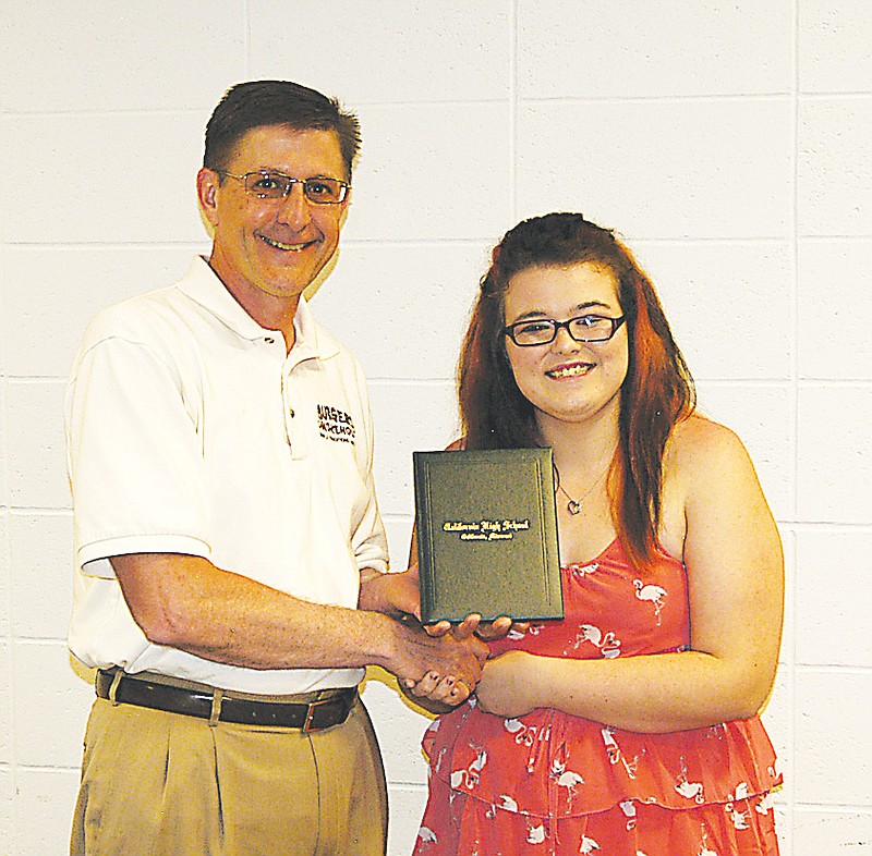 Democrat photo / David A. Wilson
Alyssa Wright, left, receives a California High School diploma  presented by Board President Steven Burger at the regular school board meeting Wednesday, June 19. She completed the Option Program.