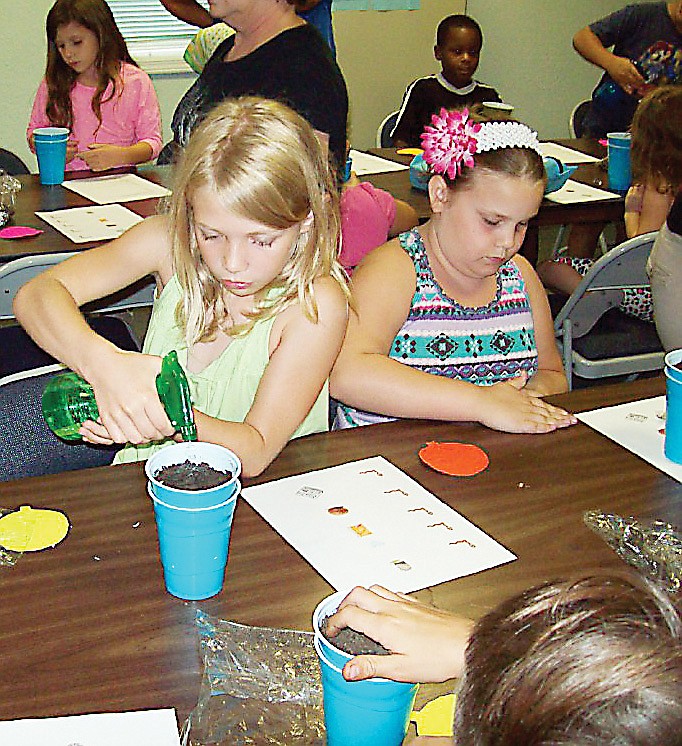 Photo submitted
Children built mini compost bins during the summer reading program at Wood Place Library Thursday evening.