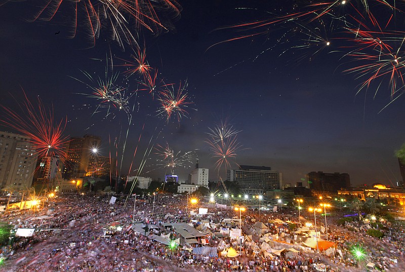 Fireworks burst Tuesday over opponents of Egypt's Islamist President Mohammed Morsi in Tahrir Square in Cairo, Egypt. With a military deadline for intervention ticking down, protesters seeking the ouster of Egypt's Islamist president sought Tuesday to push the embattled leader further toward the edge with another massive display of people power.