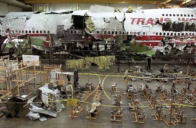 This July 16, 2001 file photo shows the seats, foreground, and the wreckage of TWA Flight 800 in a hangar in Calverton, N.Y. Current and former federal officials who played key roles in the investigation of one of the nation's worst aviation disasters said Tuesday, July 2, 2013 they stand by their conclusion that the crash of flight 800 was caused by an accidental fuel tank explosion, and not a bomb or missile.