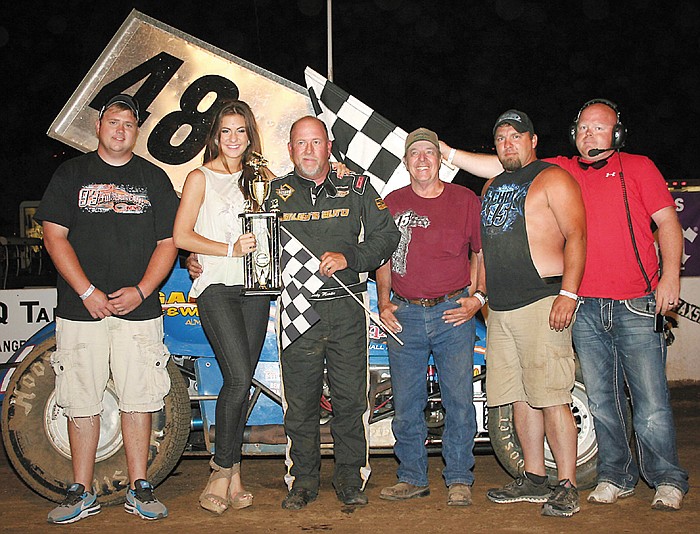 California's Randy Martin celebrates his 360 Winged Sprint feature victory with car owner David Brown, Marshall, Sunday night at the Double-X Speedway. From left are Randy's son Evan Martin, Jefferson City; Double-X Trophy Girl Kassi Meisenheimer, California; Randy and Brown; crew member Andy Carpenter, Marshall; and Double-X Speedway official Chris Winters, California. 