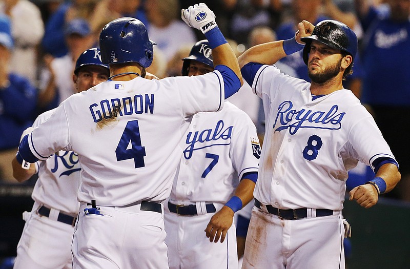 The Royals' Alex Gordon (4) is congratulated by teammate Mike Moustakas (8) after hitting a grand slam off Indians starting pitcher Corey Kluber during the fifth inning Tuesday at Kauffman Stadium in Kansas City.