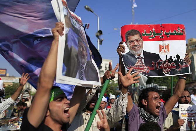 Supporters of ousted Egypt's Islamist President Mohammed Morsi chant slogans Thursday during a rally in Nasser City, Cairo, Egypt. The chief justice of Egypt's Supreme Constitutional Court was sworn in Thursday as the nation's interim president, taking over hours after the military ousted Mohammed Morsi.