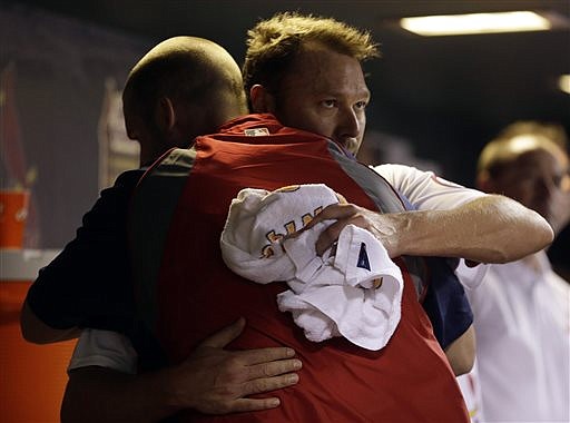 Cardinals starter Jake Westbrook (behind) gets a hug from Chris Carpenter after being pulled from Friday night's game against the Marlins at Busch Stadium.