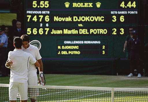 Novak Djokovic speaks with Juan Martin Del Potro after winning their men's singles semifinal match Friday at Wimbledon.