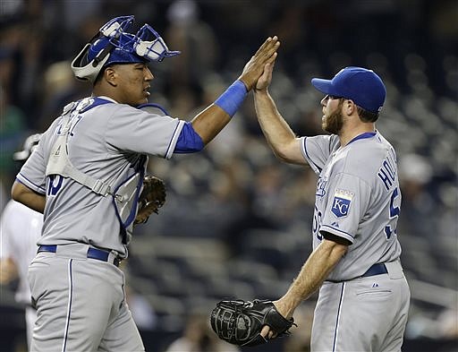 Royals catcher Salvador Perez and closer Greg Holland celebrate after Monday night's 5-1 victory against the Yankees in New York.