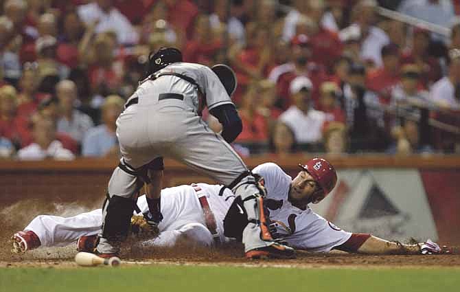 St. Louis Cardinals' David Freese is tagged out at home by Houston Astros catcher Jason Castro as he tried to score from third on a ball hit by Jon Jay in the fourth inning of a baseball game, Tuesday, July 9, 2013, in St. Louis.