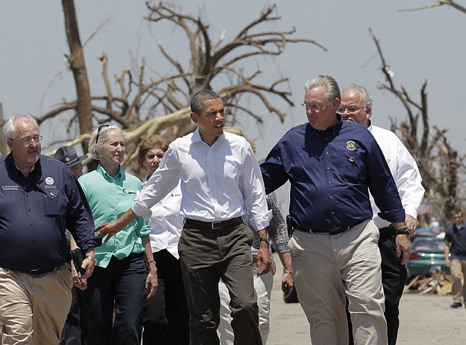 President Barack Obama walks with Gov. Jay Nixon, right, and FEMA Director William Craig Fugate, left, as they view damage a week after the May 22, 2011, tornado devastated Joplin. 