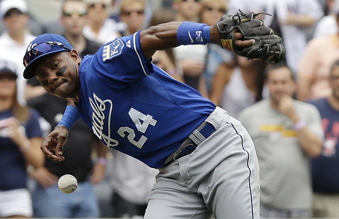 The Royals' Miguel Tejada can't make the throw to first on the Yankees' Derek Jeter's single during the first inning Thursday at Yankee Stadium in New York.