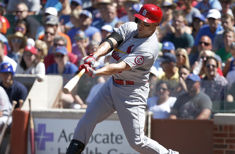 The Cardinals' Carlos Beltran hits an RBI triple off Cubs starter Carlos Villanueva during the first inning of Friday's game in Chicago.