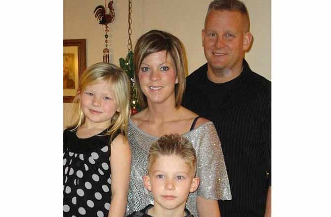 This undated photo provided by Melissa Nelson shows Melissa with her husband, Steve, and their children in Fort Dodge, Iowa. The Iowa Supreme Court on Friday, July 12, 2013 stood by its ruling that Fort Dodge dentist James Knight acted legally when he fired Melissa Nelson, his longtime assistant, because he had grown too attracted to her and worried he would try to start an affair. The court found that bosses can fire employees that they and their spouses see as threats to their marriages, fairly or not, and said such firings do not count as illegal sex discrimination because they are motivated by feelings, not gender.