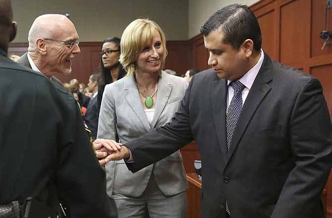 George Zimmerman, right, is congratulated by his defense team after being found not guilty during Zimmerman's trial in Seminole Circuit Court in Sanford, Fla. on Saturday, July 13, 2013. Jurors found Zimmerman not guilty of second-degree murder in the fatal shooting of 17-year-old Trayvon Martin in Sanford, Fla. The six-member, all-woman jury deliberated for more than 15 hours over two days before reaching their decision Saturday night. 