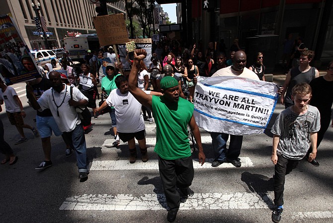 Protesters march Sunday in Chicago over the acquittal of George Zimmerman in Sanford, Fla., in the shooting death last year of 17-year-old Trayvon Martin. 