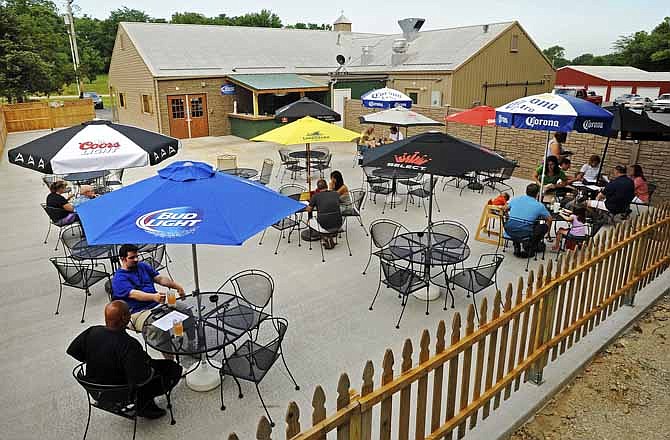 Opening day customers take advantage of the warm conditions while dining on the expansive patio at Veit's Pub & Grill on Saturday afternoon in Jefferson City.