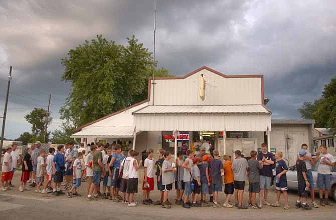 Boy Scouts gather outside Scott's Iconium Store as they prepare to walk back to the H. Roe Bartle Boy Scout Reservation after having a treat of pink Nehi floats in Iconium, Mo. Hiking from the camp to the store to get the peach float has become somewhat of a tradition among the scouts. 