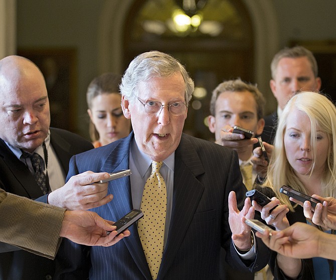 Senate Republican Leader Mitch McConnell of Kentucky is surrounded by reporters as he returns to his office after meeting with Senate Majority Leader Harry Reid, D-Nev., at the Capitol in Washington, Monday, July 15, 2013. The Senate Democrats that make up the majority and the Republicans that comprise the minority are gathering in a rare closed-door meeting in the Old Senate Chamber for a showdown over presidential nominees that have been blocked by a GOP filibuster.