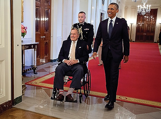 President Barack Obama and former President George H. W. Bush arrive to present the 5,000th Daily Point of Light Award to Floyd Hammer and Kathy Hamilton, a retired couple and farm owners from Union, Iowa.