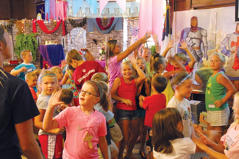 Students dance for joy Tuesday in Central Christian Church's sanctuary, which had been transformed into a royal courtyard for its vacation Bible school, "Kingdom Rock." The biblical fun continues today and Thursday at the church, located just outside of Fulton.