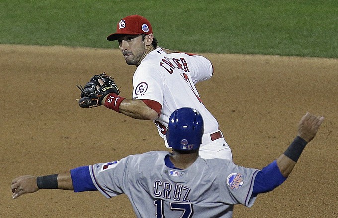 Matt Carpenter of the Cardinals avoids Nelson Cruz of the Rangers while turning a double play during the seventh inning of the All-Star Game in New York.